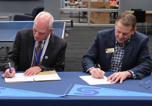 Dr. Paul Illich, SCC president, and Bill Motzer, vice president for enrollment management at NWU, sign the Biotechnology Pathway Agreement. 