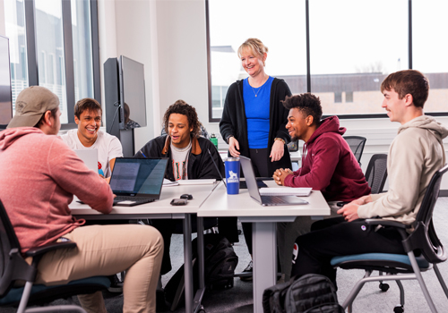 Students talking to an instructor at the Lincoln Campus.