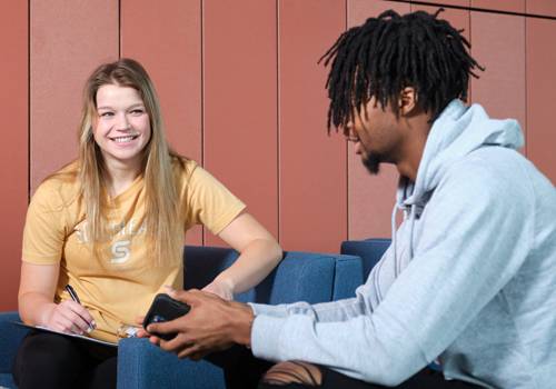 Two SCC students in Beatrice discuss an assignment.