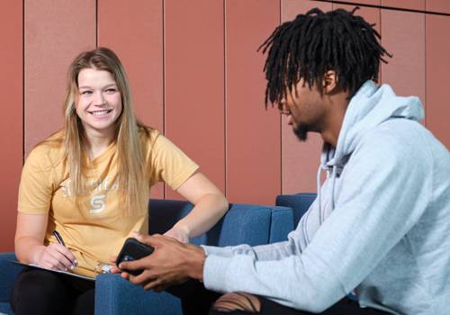 Two SCC students in Beatrice discuss an assignment. 