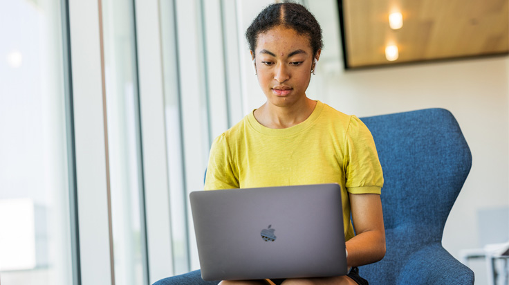 Female student using laptop